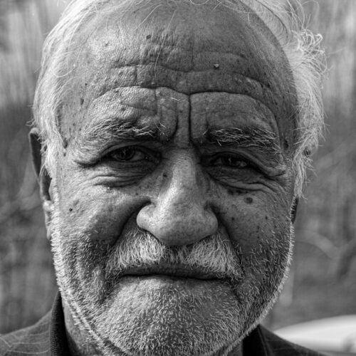 man in black coat grayscale photo